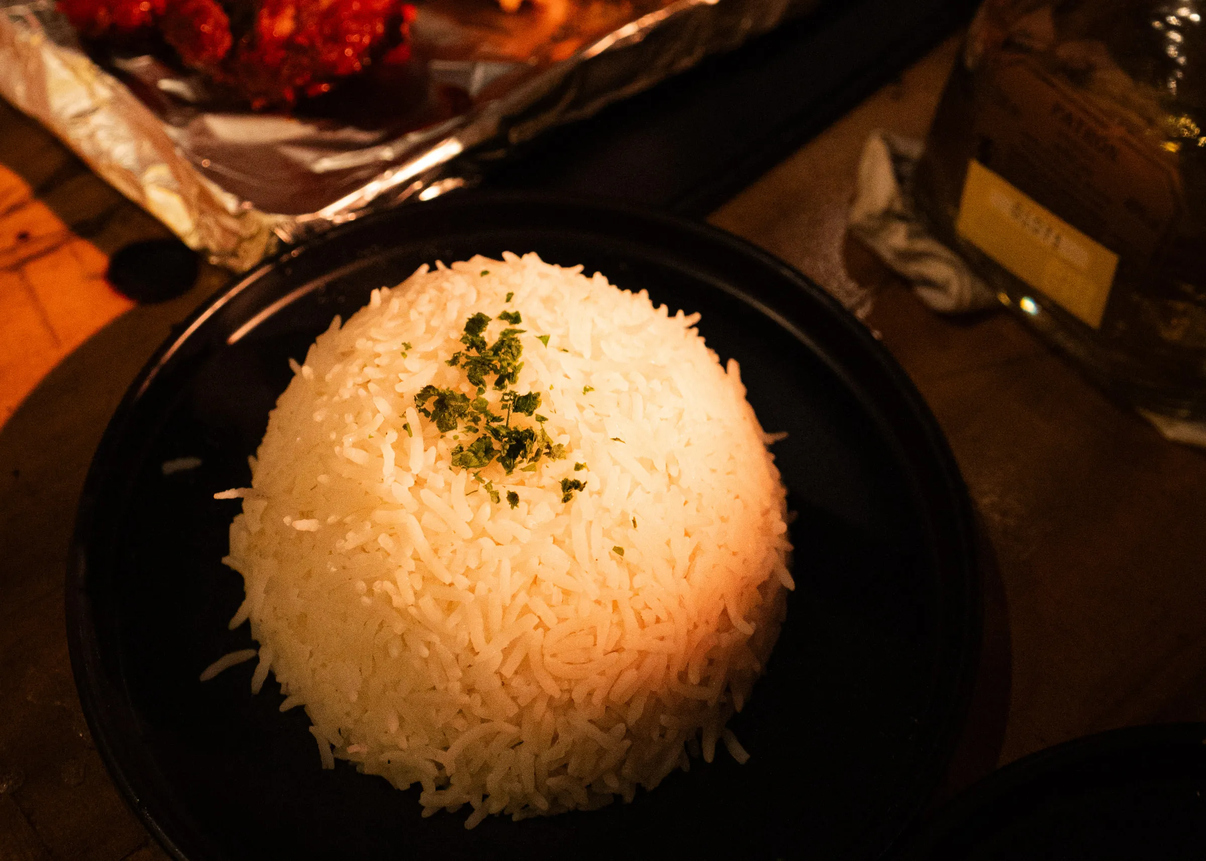 A plate of rice, the wings tray behind it