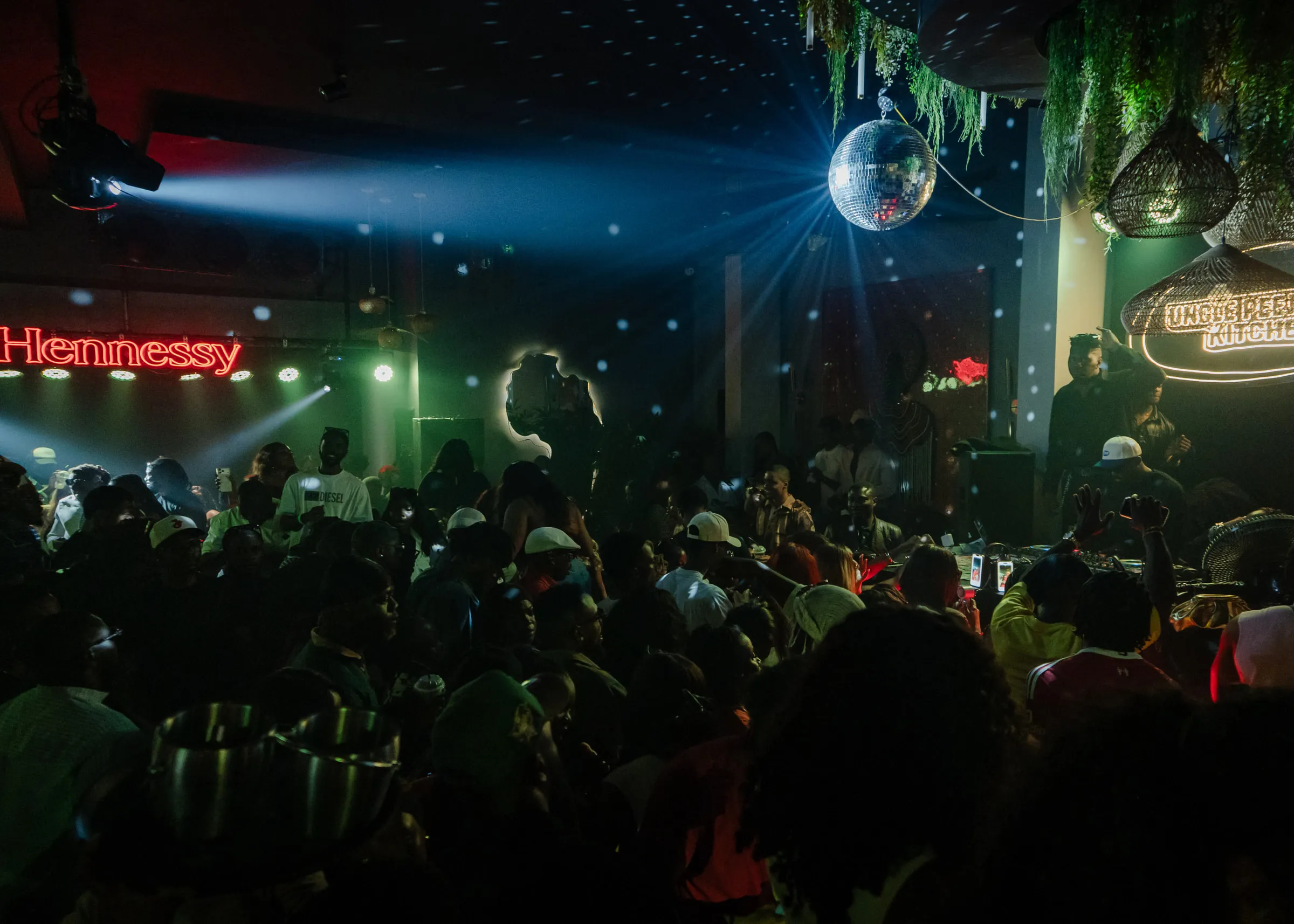 The room under the disco ball and the Hennessy sign