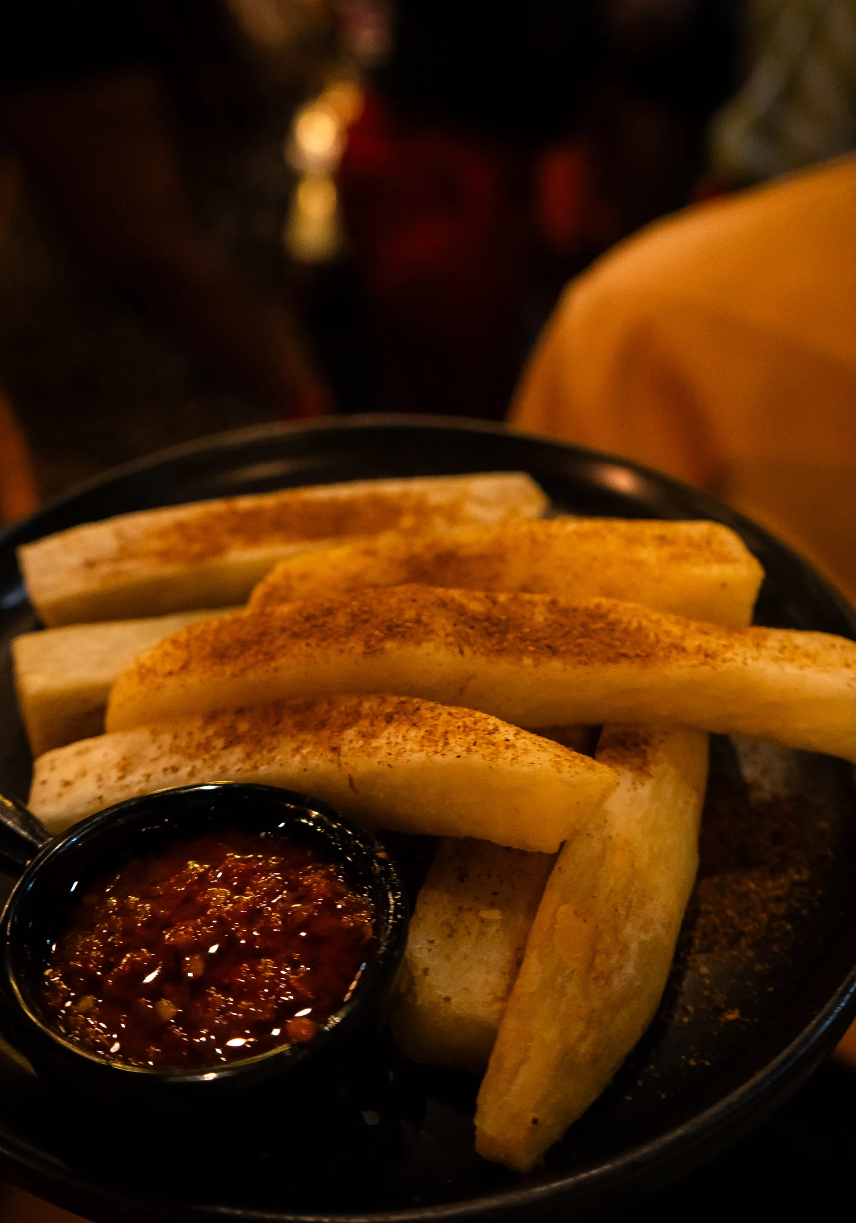 Spiced yam with a pot of pepper sauce
